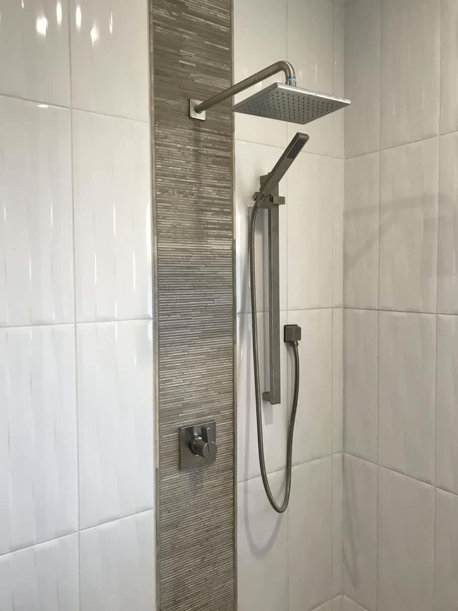 Finished tile shower with new fixtures from a bathroom remodel